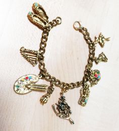 a close up of a bracelet with charms on it