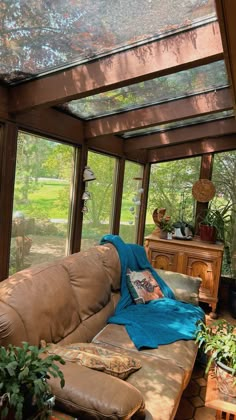 a living room filled with furniture and lots of glass walls on top of it's roof