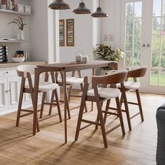 a kitchen table with four stools in front of it