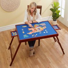 a woman sitting at a table with a puzzle on it