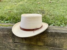 "Upgrade your favorite hat with a custom and customizable leather hat band. Perfectly adjustable to fit any size hat and can be secured in multiple ways to customize your style. Each hat band is handmade from substantial and durable full-grain vegetable tanned leather. Made to your order, the leather is cut, dyed, and finished. The edges are then beveled, burnished, and sealed for a smooth feel. Bands are 5/8\" wide. Sizes are based on the length of the wide part of the leather and can fit a ran Leather Hat, Leather Hats, Silver Spring, Hat Band, Vegetable Tanned Leather, Panama Hat, Tan Leather, Cowboy Hats, Grain