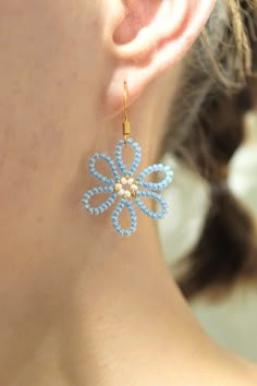 a close up of a person wearing some kind of earring with beads on it