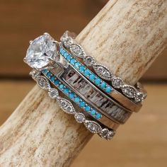 a stack of rings with blue and white stones