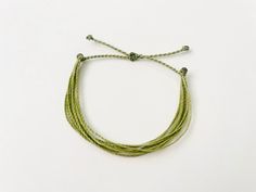 This fun and simple sage green string bracelet is waterproof and adjustable, making it great for anyone who is often doing outdoor activities. It would make a nice gift. Stack it with other bracelets, or wear it by itself! It is perfect for everyday wear! ∙ ∙ ∙ ∙ ∙ ∙ ∙ ∙ ∙ ∙ ∙ ∙ ✦ PLEASE NOTE ✦ When you first receive this bracelet, it may feel slightly waxy, which may make it more difficult to adjust. The waxy texture does not last. After a day or two of wearing, the waxy texture will fade, and Sage Green Bracelet, Green String Bracelet, Bracelet Thread, Bracelet String, Thread Bracelet, Surfer Bracelets, Green Bracelet, Thread Bracelets, String Bracelet