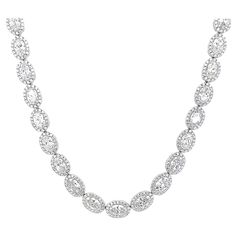 Stunning oval diamond tennis necklace east-west. High jewelry by Alexander Beverly Hills. 22.18 carats total diamond weight. 45 oval diamonds, 18.55 carats total. Approximately F/G color and SI1 clarity. Complimented with 730 round brilliant diamonds, 3.63 carats. Approximately E/F color and VS clarity. Four prong set in 18k white gold, 30.58 grams, 16 inches. Accommodated with an up-to-date digital appraisal by a GIA G.G. once purchased, upon request. Please contact us with any questions. Item Number NS1760 Diamond Tennis Necklace, Tennis Necklace, East West, Oval Diamond, High Jewelry, Halo Diamond, Oval Shape, Item Number, Round Brilliant