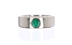 A masculine, modern men's ring made in 14K white gold. This ring is made with the finest, genuine materials from our emerald collection. The round emerald is natural and bezel set in smooth white gold. This ring is comfortable to wear daily. Setting Style: Bezel Setting Weight: 10 Grams 14K Setting Material: 14K White Main Stone: Emerald Grade Quality: AA+ Shape: Round Cut Stone Measurements: 5.3 mm Weight: approx 0.70 pts Cut: Good Clarity: Translucent Hue: Medium Dark Color: Green Luster: Exce Modern Gemstone Signet Ring, Modern Round Emerald Ring For Formal Occasions, Modern White Gold Emerald Ring For Formal Occasions, Modern White Gold Emerald Ring With Vvs Clarity, Modern White Gold Emerald Ring With Round Cut, Modern Formal Emerald Ring, Modern Emerald Ring With Bezel Setting For Formal Events, Modern Emerald Ring With Bezel Setting For Formal Occasions, Modern White Gold Emerald Ring With Bezel Setting