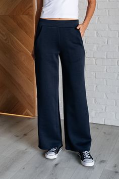 Get ready to slay in style with our Resort Travel Wide Leg Crop Pant! These pants feature a chic navy color and a trendy wide leg design, perfect for any occasion. The banded and elastic waistline provide both comfort and style, while the functional side pockets add convenience. Made from scuba modal fabric, these pants are a must-have for your wardrobe. Scuba Modal Banded Waistline Cased Elastic Back Waistline Functional Side Pockets Wide Leg 95% Polyester, 5% Spandex True to Size S: Waist 27" Magenta Color, Travel Pants, Color Making, Modal Fabric, Wide Leg Cropped Pants, Denim Leggings, Half Zip Pullover, Leg Design, Romper Dress