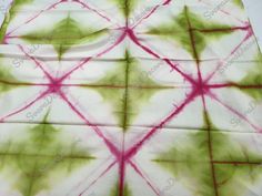 tie - dyed cloth with red and green designs on it