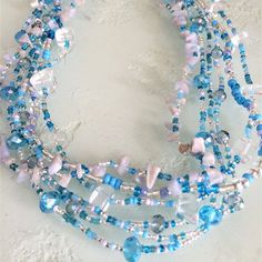 Artisan Czech Glass Bead 6 Strand 18" Long Fashion Statement Necklace Lt. Blue & Crystal A Total Length Of 18" Long, With Glass Beads & Semi Precious Stone Chips. Easy To Open/Close Magnetic Clasp. One Of A Kind Necklace Handcrafted/No Two Are Exactly Alike Czech Glass Beads Are Know World Wide For Their Quality, Vibrant Colors Handmade In Guatemala Using Artisan Crafted Czech Glass Beads. Principles Of Fair Trade Are Upheld. Bohemian Blue Glass Beads, Blue Glass Beaded Bohemian Necklace, Blue Glass Bohemian Beaded Necklaces, Bohemian Blue Glass Beaded Necklaces, Blue Jewelry With Silver Beads For The Beach, Blue Glass Bohemian Necklace, Blue Glass Beaded Necklaces, Blue Glass Beaded Necklaces With Polished Beads, Bohemian Blue Czech Glass Necklaces