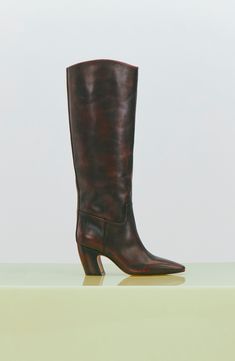 A minimalist design brings wardrobe-spanning versatility to this leather knee-high boot framed with a snipped toe and sculptural setback heel. 3" heel 15 1/4" shaft; 15" regular calf circumference 15 1/4" shaft; 16" wide calf circumference Inset side-zip closure Leather upper/synthetic lining/rubber sole Imported Knee High Boots Street Style, Boots Street Style, Dark Caramel, Knee High Leather Boots, Wide Calf, Fabric Gift Bags, Anniversary Sale, Vince Camuto, Knee High Boots