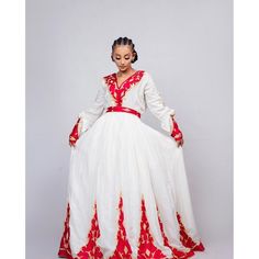 This Habesha dress is a true work of art, made of soft and luxurious Menen fabric in a regal red color. The dress features a stunning Tilf embroidery design, covering the entire dress with intricate patterns and designs that are unique to Ethiopian traditional clothing. The Tilf embroidery adds a touch of elegance and sophistication to the dress, featuring delicate patterns and designs that are sure to turn heads. The dress is designed with a fitted bodice that accentuates the waistline and flar Traditional Fitted V-neck Dress, Ceremonial Long Sleeve Dresses For Festivals, Traditional Red Maxi Dress For Wedding, Traditional Red Floor-length Dress, Red Floor-length Gown For Traditional Ceremonies, Traditional Red Maxi Length Dresses, Long Ceremonial Dress For Festivals, Traditional Festive Gown For Gala, Traditional Red Gown With Long Sleeves