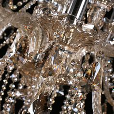 a crystal chandelier hanging from the ceiling with lots of crystals on it's sides