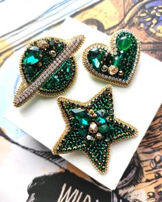 This beautiful emerald colour set of 3 brooches ! "Star, Saturn and heart" handembroidered using Japanese, Czech and faceted glass beads, metal thread, natural agate stone, chrystal's and sequins.The price is for 3 brooches!!! Dimensions: Star 5.5 cm 5.5 cm Heart 4 cm 3.5 cmPlanet 7 cm 4 cm Celestial Brooch Jewelry As Gift, Elegant Star-shaped Brooch Jewelry, Luxury Elegant Star-shaped Brooches, Beaded Earth Brooch, Luxury Star-shaped Brooch Jewelry, Heart Hands, Emerald Color, Heart Brooch, Beaded Brooch