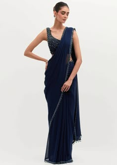 The signature and bestseller navy blue masoom sari! Embroidered in pearls all over, with a featured embroidered cape. Dark Blue Sequin Saree, Dark Blue Indian Outfit, Embroidered Saree With Cape Sleeves For Wedding, Wedding Saree With Embroidered Cape Sleeves, Blue Farewell Saree, Traditional Pre-draped Saree With Pearl Embroidery For Evening, Navy Blue Saree Party Wear, Midnight Blue Saree, Elegant Blue Silk Pre-draped Saree