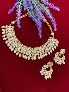 High gold plated designer Tyaani Kundan set with matching Chandbali. Next to real anti tarnish platting, hypoallergenic. Suitable for anything . Can be worn as a necklace or choker. About 1.5 inch wide on the neck. Earring is 2 inch long , push back and very very light weight . Ceremonial Tilla Choker Jewelry, Intricate Design Bridal Choker For Festivals, Ceremonial Hand-set Bridal Choker Necklace, Festival Bridal Necklace With Intricate Design Choker, Chandbali Hand Set Choker For Festivals, Intricate Design Kundan Choker Necklace For Celebration, Kundan Choker Necklace With Intricate Design For Celebration, Heavy Temple Choker Necklace For Wedding, Festive White Choker Necklace