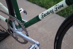 there is a green bike with white lettering on the front and back tire rims