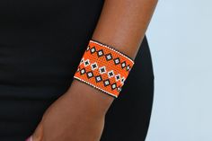 African beaded bracelets, Maasai Cuff Bracelets, Maasai Wrist bracelets, Beaded bangles, Beaded Cuff bracelets, Christmas gift, Moms gift The bracelet is made by the Maasai women in Kenya.  It is beautiful and can compliment any outfit. Available in medium and large size Medium size: fits a standard wrist size of 7.5 inches Large Size: fits a wrist size of 8.5 inches Shipping fee is for the first item only. Other items ship for FREE! Shipping via DHL Express that takes 3-5 days to be delivered. To view more items from our shop, kindly click here: nkoroicrafts.etsy.com Thank you for visiting! Maasai Bracelet Kenya, Orange Beaded Bangle Bracelet As Gift, Handmade Orange Cuff Bracelet Gift, Handmade Orange Cuff Bracelet Bangle, Handmade Orange Cuff Bangle, Handmade Orange Bangle Cuff Bracelet, Beaded Cuff Bracelet Gift, Handmade Beaded Cuff Bracelet As Gift, Traditional Beaded Wristband Gift