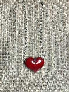 Handmade in Ecuador (Heart 2.5”, .5” thick) Necklace Length: 18 Inches Materials: Tagua, stainless steel chain necklace Due to this item being handmade and the nature of the Tagua Nut the size and the color may vary from piece to piece Red Stainless Steel Pendant Jewelry, Red Stainless Steel Jewelry For Valentine's Day, Personalized Red Stainless Steel Jewelry, Handmade Red Heart-shaped Jewelry, Unique Red Heart-shaped Necklace, Red Large Pendant Jewelry For Gift, Unique Red Heart Shaped Jewelry, Red Jewelry With Large Pendant For Gift, Red Stainless Steel Necklace With Adjustable Chain