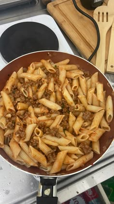 a pan filled with pasta on top of a stove