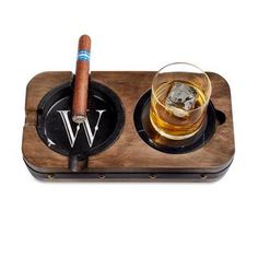 This distinguished double-duty piece is a fast favorite among cigar and whiskey aficionados. Crafted from acacia wood with a metal barrel hoop accent, it echoes the signature look of aged whiskey barrels. A removable black marble ashtray and leather coaster elevates your cigar-and-whiskey moments with the luxurious details it deserves. Whether by the fire or on the patio, this formidable companion can be carried anywhere you like to settle in. Whiskey Tray, Cool Whiskey Glasses, Cigars Accessories, Wood Ashtray Cigars, Aged Whiskey, Whiskey Barrel Furniture, Bourbon Gifts, Whiskey Set, Metal Barrel