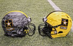 two football helmets sitting on top of a field