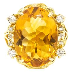 Gorgeous yellow orange color oval faceted citrine accented with 4 prong set approximate size .08 carat diamonds and six 3 prong set approximate .02 carats diamonds. Approximate total weight in diamonds is .44 carats. The sides have open scroll design that resembles a heart. The citrine measures 13.5mm x 8.5mm. The ring is 10k yellow gold. US size 8.5. It can be sized. Diamond Dress Ring, Yellow Gold Cocktail Ring, Gold Starburst, Citrine Jewelry, Yellow Jewelry, Vintage Jewelry Art, Yellow Rings, Jaune Orange, Gold Cocktail Ring