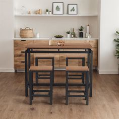 a kitchen table with four stools in front of it and shelves on the wall