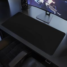 a computer monitor sitting on top of a black desk next to a keyboard and mouse