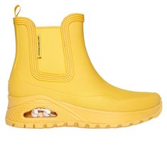 Get iconic style and comfort rain or shine with Skechers Street Uno Rugged - Dancing N The Rain. This fashion rain boot features a waterproof synthetic upper with a cushioned Skechers Air-Cooled Memory Foam insole, and a Skech-Air visible airbag midsole. | Skechers Women's Uno Rugged - Dancing N The Rain Boots | Medium Width | Skechers Air-Cooled Memory Foam cushioned comfort insole | Skech-Air visible airbag midsole | Pull-on synthetic upper | Flexible traction outsole | 1 1/2-inch heel height Yellow Waterproof Rain Boots, Rain Boots Fashion, Lace Up Wedges, Wide Shoes, Rain Or Shine, Rain Boot, Shoes Flats Sandals, Skechers Women, 2 Inch Heels