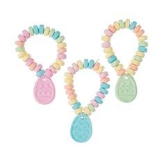 three necklaces with charms on them and one is pink, blue, yellow and green