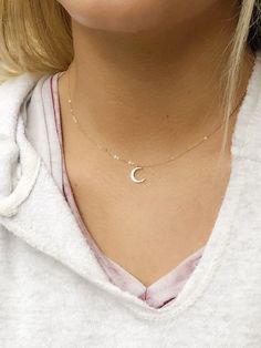 Dainty crescent moon choker necklace, perfect for layering. A dainty crescent moon charm measuring hangs from a delicate but sturdy 16 inch 14k gold filled chain. If you would prefer this necklace shorter or longer, we can make this from 14-18 inches. Just remind me in the notes to seller section. I also offer this in sterling silver Details Gold option; Gold plated crescent moon charm measuring 12mm x 17mm 14 k gold filled chain Arrives in a gift box Silver option: Sterling silver chain Rhodium Dainty Clavicle Crescent Chain Jewelry, Delicate Half Moon Necklace With Moon Phase Detail, Delicate Half Moon Jewelry With Moon Phase Detail, Delicate Half Moon Necklace With Moon Phase, Delicate Half Moon Phase Necklace, Dainty Crescent Charm Necklaces For Everyday, Dainty Moon Charm Necklace For Everyday, Minimalist Crescent Charm Necklace With Clavicle Chain, Dainty Everyday Moon Charm Necklace