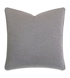 a black and white checkered pillow on a white background