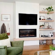 a living room filled with furniture and a flat screen tv mounted on the wall above a fire place