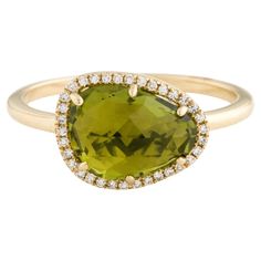 This Peridot & Diamond Ring is a stunning and timeless accessory that can add a touch of glamour and sophistication to any outfit. This ring features a 2.41 Carat Peridot (12 x 9 MM), with a Diamond Halo comprised of 0.08 Carats of Single Cut Round White Diamonds. This ring is set in 14K Yellow Gold. Ring Size is 6 1/2. Green Diamond Rings With Gemstone Accents, Green Diamond Ring With Gemstone Accents For Formal Occasions, Wedding Jewelry With Brilliant Cut Peridot, Formal Green Gemstone Diamond Ring, Green Gemstone Diamond Ring For Formal Occasions, Formal Green Diamond Ring With Gemstone Accents, Elegant Peridot Diamond Ring As A Gift, Modern Green Diamond Wedding Ring, Formal Lime Green Rings With Center Stone