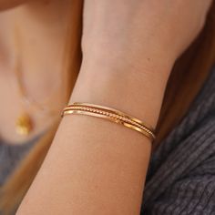 This handmade gold fill cuff bracelet is the perfect accessory for modern elegance and timeless style. Its sleek, clean design ensures it will pair with any look, and its quality craftsmanship makes it safe for everyday wear. Non-tarnishing and water safe. Wear one for a standalone statement piece, or stack multiples with a range of styles - these cuffs are beautiful no matter your style. Bracelet Kada For Women, Gold Chain Bracelet For Women Classy, Gold Stackable Cuff Bracelet For Everyday, Gold Kada Bracelet For Women, Elegant Gold Bracelet Simple, Gold Minimalist Cuff Bracelet, Dainty Bangle Cuff Bracelet For Everyday, Dainty Everyday Cuff Bangle, Dainty Everyday Cuff Bangle Bracelet