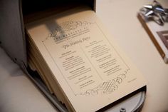 a wedding program in a box on a table