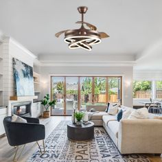 a living room filled with furniture and a ceiling fan