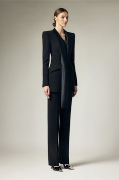 With its sleek satin crepe material and structured design, this blazer exudes sophistication and exclusivity. The extended flap adds a touch of elegance to this already refined piece. Elevate any outfit with this must-have blazer. Chic Evening Blazer With Lapel Collar, Elegant Semi-formal Pantsuit With Pressed Crease, Tailored Satin Blazer For Semi-formal Occasions, Luxury Long Sleeve Formal Pantsuit, Designer Evening Outerwear With Concealed Placket, Chic Silk Suits For Office, Tailored Long Sleeve Evening Pantsuit, Luxury Semi-formal Pantsuit With Lapel Collar, Luxury Lapel Collar Semi-formal Pantsuit