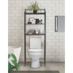 a white toilet sitting in a bathroom next to a bathtub and a plant on top of a metal shelf