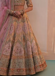 Features a gold organza double dupatta lehenga set embroidered with traditional zardozi technique using silken threads, dabka, cutdana and sequins highlighted with multiple pastel hued velvet appliques. Completed with two dupattas in rust gold and pink for your big day. Composition : Lehenga, Blouse and Dupatta- Organza, Velvet Care: Dry Clean Only and Vacuum Storage This product can be customised for sleeves, length of blouse and neckline Delivery : 6-8 weeks as the product is hand crafted. Check Size Guide or choose MySize for free customisation (All Sizes above XL can be made at 15% additional cost) For more information and sizes please contact fabiliciousfashion@gmail.com or visit our Copenhagen studio.About the Designer : Angad Singh's journey in the world of fashion started with at a Double Dupatta Bridal Lehenga, Double Dupatta Lehenga, Pastel Bridal Lehenga, Double Dupatta, Dupatta Bridal, Embroidery Zardozi, Gold Organza, Gold Lehenga, Indian Bridal Sarees