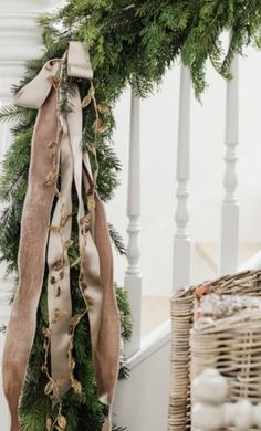 a christmas wreath is hanging on the banister