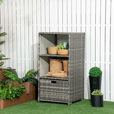 an outdoor storage unit with plants and potted plants