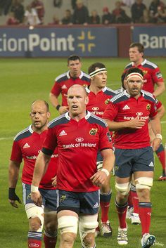 the rugby players are walking on the field