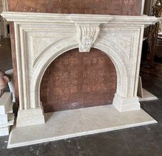 a white marble fireplace surround in a room