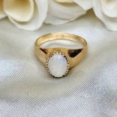 "Beautiful vintage ladies' ring circa 1960's. Signet style hand wrought ring in 10k yellow gold featuring a beautiful prong set Opal cabochon. Size 6 US. Weighs 3g. Stamped \"10k\" on the inside of the band along with the letter \"M\" (owner's monogram). Some very minor surface marks on the gold that could be buffed out. In overall excellent vintage condition!" Classic Gold Opal Gemstone Ring, Vintage Oval Dome Ring As A Gift, Classic Moonstone Cabochon Ring For Anniversary, Vintage Oval Dome Ring Gift, Heirloom Gold Opal Ring With Cabochon, Heirloom Gold Opal Cabochon Ring, Vintage 14k Gold Cabochon Opal Ring, Vintage Solitaire Signet Ring, Vintage Opal Ring Stamped 14k