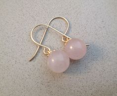 Delicate and tasteful pair of natural Rose Quartz earrings. Each earring is made of a round smooth bead of natural Rose Quartz and a Gold Deeped setting. Each bead is 8.00mm in diameter. If you prefer, we can also prepare these earrings with smaller beads, size 6.00mm. Material: Gold Filled For more earrings: http://etsy.me/2ru2olL Elegant Nickel-free Rose Quartz Earrings, Rose Quartz Ear Wire Earrings For Gift, Rose Quartz Earrings With Ear Wire As Gift, Rose Gold Earrings With Round Beads For Gift, Gem Stone Earrings, Romantic Gifts For Wife, Bracelets Ideas, Gemstone Earrings Gold, Horse Necklace