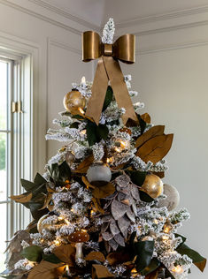 a decorated christmas tree with gold and silver decorations