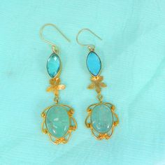 Sky Blue Topaz Earrings- Aqua Crackle Glass Gemstone Earrings- Gold Plated Drop Earrings- Topaz Jewelry- Fashion Earrings for Women Description : Metal : Brass Plating : Gold Plated Stone : Sky Blue Topaz Hydro and Aqua Crackle Glass Length : 70 x 17 mm Approx Weight : 11.46 Gram Approx Stone Size : 16 x 7 mm approx marquise topaz, 17 x 13 mm approx oval crackle glass ❣❣ Handmade Item ❣❣ **Made to Order** » G EM S T O N E D E T A I L « **Gemstone structure may vary from the image as two gemstone Handmade Blue Drop Earrings, Elegant Turquoise Danglers As A Gift, Elegant Turquoise Danglers For Gift, Blue Danglers For Gift, Blue Elegant Handmade Danglers, Handmade Blue Elegant Danglers, Dangle Earrings Gold, Gemstone Earrings Gold, Topaz Jewelry