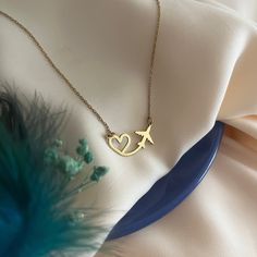 Heart and Airplane Necklace - Heart Flying Necklace - Gift for Travel Lover - Gift for Pilot - Stewardess Gift - Traveler's Necklace - Modern Jewelry - Best Friend Gift's - Valentine's Day Gift Introducing our Heart and Airplane Necklace, the perfect gift for pilots or a delightful hostess gift. This exquisite necklace combines elegance with a touch of wanderlust, making it a unique and thoughtful present for aviation enthusiasts or those who love to travel. Material - High Quality Handmade 925 Sterling Silver - 18K Gold Plated and 18K Rose Plated - High Quality Handmade 8K REAL GOLD and 14K REAL GOLD - 8K & 14K REAL ROSE GOLD and 8K & 14K REAL WHITE GOLD Preparation and Shipping : - The processing time of all our products is 3-5 working days. - You can send us a message for fast shipping Unique Gift Ideas For Best Friend, Pilot Necklace, Gifts For Pilot, Aviation Jewelry, Necklace Photography, Airplane Jewelry, Necklace Travel, Airplane Necklace, Travel Inspired Jewelry