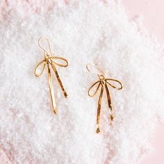 On a pink snowy background is a pair of gold bow shaped earrings. Snowy Background, Jewelry Style, Bow Earrings, Christmas Earrings, Delicate Earrings, Gold Christmas, Gold Hoops, Silver Hoops, You Choose